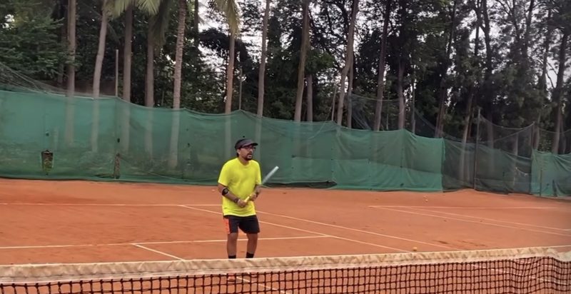 Playing tennis on a clay court