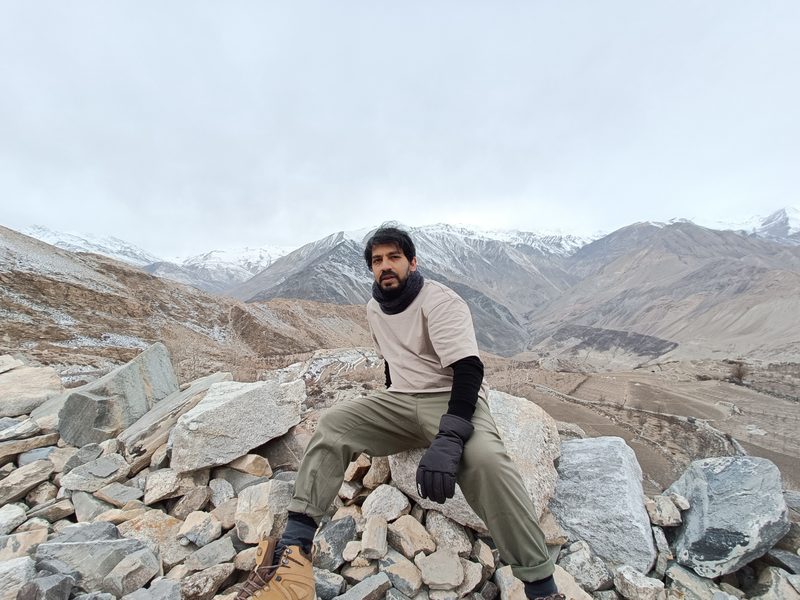 Sitting on rocks overlooking a Himalayan valley